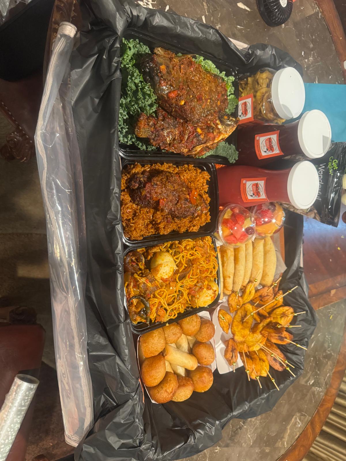 Food box with grilled fish, jollof, puff puff and dodo