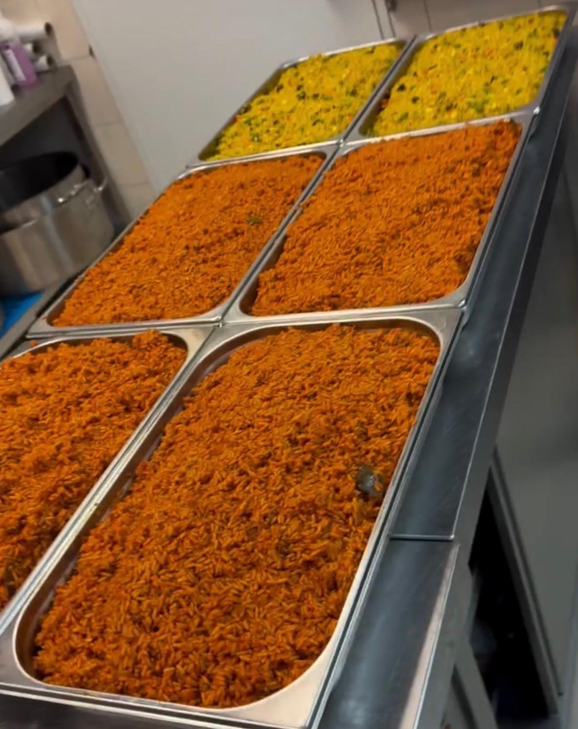 Large trays of freshly cooked jollof and fried rice